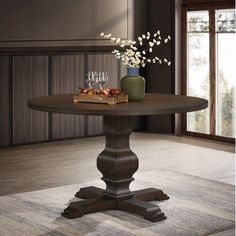 a dining room table with two vases on it and some fruit in the middle