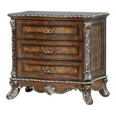 an ornate wooden chest with three drawers