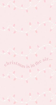 a pink wallpaper with hearts and the words christmas is in the air on it