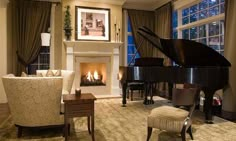 a living room filled with furniture and a grand piano in front of a fire place