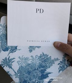 a person holding up a piece of paper with the word pd on it