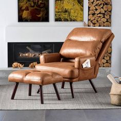 a leather recliner chair and ottoman in front of a fireplace