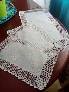 two white doily sitting on top of a wooden table