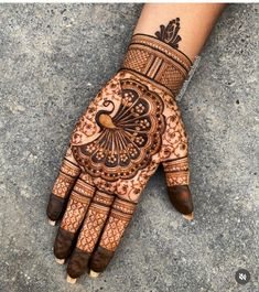 a henna on someone's hand with intricate designs