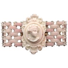 Highly elegant bracelet carved out of pink shell and mounted in 14 k gold. A bust in the antique manner of the goddess Flora sits in an oval frame decorated with scrolled leaves and greek key pattern elements. The bracelet is made out of rectangular shell batons that are held together by golden rods to form a kind of gate bracelet. All the elements of the bracelet are flexible. The cameo is mounted on a rectangular golden clasp. The bracelet has been carved in Italy around 1875-1880. The bracele 18k Gold Bangle, Grandmother Jewelry, Cameo Bracelet, Coral Bracelet, Popular Jewelry, Antique Pink, Cameo Pendant, Elegant Bracelet, Rose Gold Bracelet