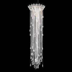 a crystal chandelier hanging from the ceiling in a dark room with black walls