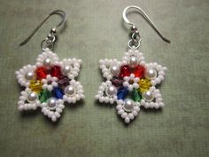 a pair of white beaded earrings with multicolored beads