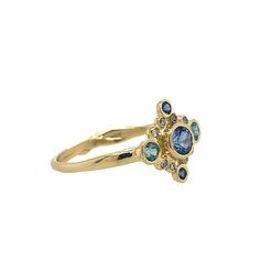 Look no further for your something blue, because this is it. The perfect dainty piece for every day or special occasions. A brilliant Sapphire is surrounded by Diamonds, Sapphires and Blue Zircons to make the perfect cluster ring. Set in 14k yellow gold with Emily's signature gold band this is definitely not a boring engagement ring. Approximate center stone size: 4mmx x 4mm Approximate tcw of diamonds: .10 ct This piece is handmade to order in Emily's Hudson Valley studio. Please allow for slig Handmade Engagement Rings, Local Jewelry, Blue Zircon, Cornflower Blue, Diamond Cluster, Sapphire Diamond, Cluster Ring, Something Blue, Gold Bands