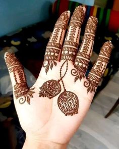 the hand is decorated with henna designs