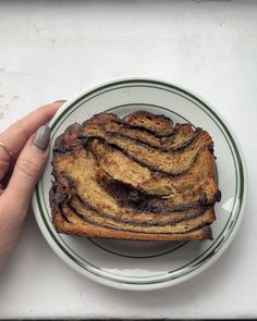 a person holding a plate with some food on it