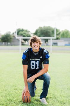 a man kneeling down with a football in his hand