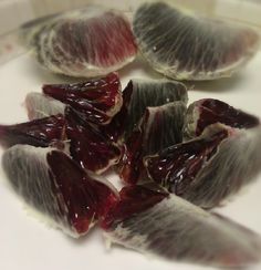 several pieces of fruit sitting on top of a white plate