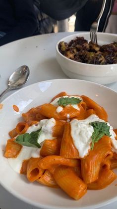 a white plate topped with pasta and sauce