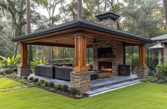 a covered patio with fireplace and seating area