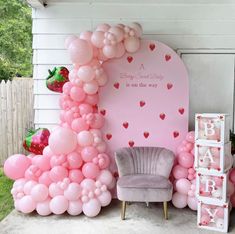 a baby shower is decorated with pink balloons and heart - shaped archs for the entrance