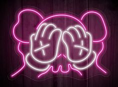 a pink neon sign with two hands in the shape of a mouse