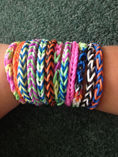 several different colored bracelets on someone's arm