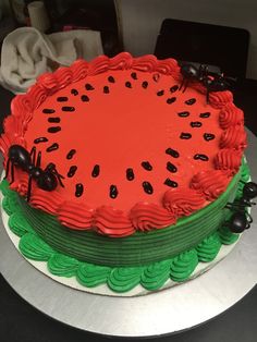 a watermelon cake with black ants on top