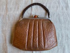 "Adorable vintage 40s 50s brown leather handbag for women. Measures - height - 24cm (9.4\") width - 31cm (12.2\") In good vintage condition, inside canvas is damaged from one side and outside bottom corners need fixing. Real colours may be little different from their appearance on your display. Pleas look at the pictures carefully and i will be happy to answer all of your questions. Feel free to visit my shop for other vintage goods: www.etsy.com/shop/SkySecrets" Vintage Evening Bags With Leather Lining, Mid-century Brown Shoulder Bag For Travel, Retro Vintage Brown Shoulder Bag With Leather Handles, Vintage Light Brown Bags For Everyday Use, Vintage Light Brown Bag For Everyday Use, Retro Cognac Satchel Bag, Vintage Brown Retro Satchel For Daily Use, Vintage Cognac Satchel With Detachable Handle, Retro Satchel With Leather Handles