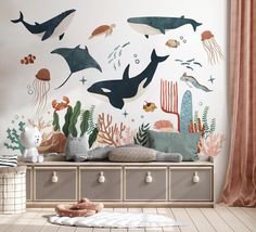 a child's room with an ocean theme wall mural and toy chest in the foreground