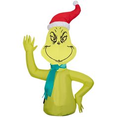 an inflatable character wearing a santa hat and green scarf waving at the camera