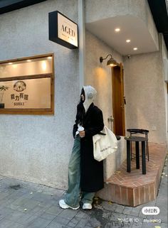 a woman standing in front of a building