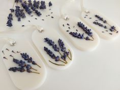 three white tags with lavender flowers on them