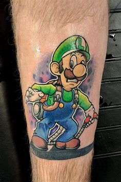 a man with a tattoo on his leg that has an image of mario in it