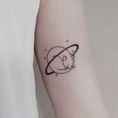 a small rat tattoo on the left inner arm, with stars and saturn in the background