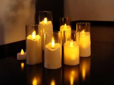 five lit candles sitting on top of a table