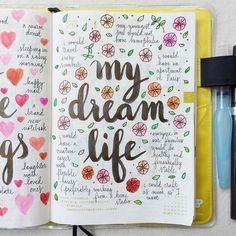 an open notebook with the words my dream life written in cursive writing on it