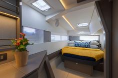 a bed sitting inside of a bedroom on top of a wooden floor next to a window