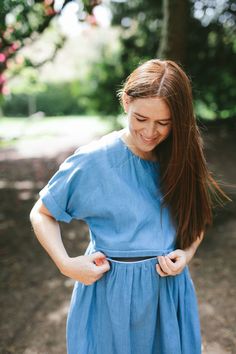 A denim look nursing dress designed for breastfeeding and maternity. A smock length dress with rolled short sleeves  and a casual fit. At Ruma Breastfeeding Wear we design dresses for nursing and maternity that match your pre baby style. Dress for breastfeeding and maternity with a unique two way, hidden zip that can be opened from either side allowing you to nurse your baby comfortably. We've added a quick video to show you how the zip works. This dress is a midi length with a tiered skirt and Summer Maternity Dress With Nursing Friendly Short Sleeves, Modest Short Sleeve Maternity Dress For Summer, Summer Maternity Dress Nursing Friendly, Short Sleeve Maternity Dress For Nursing, Relaxed Fit Denim Dress With Short Sleeves, Spring Nursing-friendly Maternity Dress, Maternity Nursing Dress With Short Sleeves, Spring Short Sleeve Bump-friendly Tops, Summer Cotton Maternity Dress Nursing Friendly