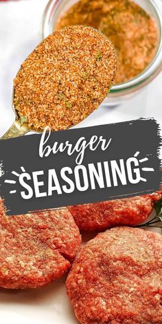 burger seasoning is being spooned over hamburger patties on a white plate with a black sign that says burger seasoning