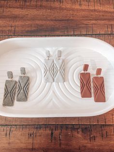 a white tray with four different shaped items on it