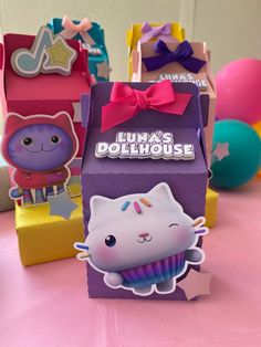 there is a small cupcake with a cat on it in front of other boxes