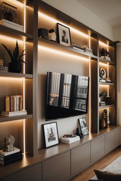 a living room filled with lots of furniture and shelves covered in pictures, books and framed photographs