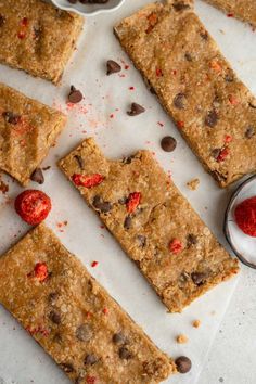 chocolate chip cookie bars cut into squares on a cutting board with red sprinkles