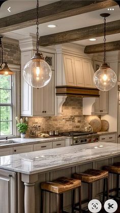 an image of a kitchen setting with marble counter tops and stools on the island