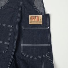 Cut from an 11.5 ounce raw Japanese denim, these 1930’s Overalls hark back to the golden age of American workwear. Superb nuances of detail can be donut throughout this design, including ‘Union’ tuck buttons on the bibs, donut buttons for the fly closure, perfectly aged, period-correct buckles for the straps, a beautifully painted cardboard brand patch, and a bold rayon woven ’31’ label on the front pocket. These wide fitting overalls would have originally been designed to be layered over the to Painted Cardboard, American Workwear, Workwear Vintage, Rockabilly Style, Japanese Denim, Rockabilly Fashion, Bib Overalls, The Golden Age, Union Made