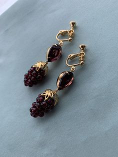 "NON PIERCED GARNET Grapes, vintage Amethyst Glass Stones, 16k Gold plated Earrings, Reproduction Historic real Garnet grape earrings Victorian reproduction earrings - grape clusters like this were very popular throughout the centuries, including the Victorian era. Small clusters of real GARNETS with gold leaf design, with matching amethyst garnet vintage glass stones mounted on gold plated brass brass settings, with high quality, 16k gold plated brass NON PIERCED clip ons with adjustable screw Elegant Gold Garnet Earrings, Elegant Garnet Gemstone Earrings, Grapes Earrings, Antique Garnet Earrings, Shifting Closet, Elegant Faceted Garnet Earrings, Gold Leaf Design, Grape Earrings, Cluster Earrings