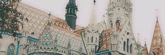 an old church with steeples and spires is shown in the foreground, surrounded by other buildings