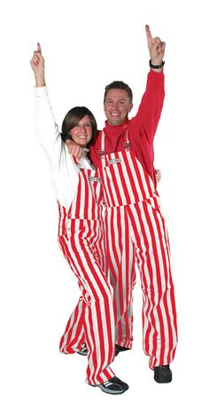 a man and woman dressed in red and white striped overalls posing for the camera