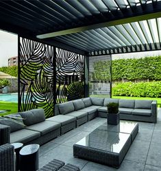 an outdoor living area with couches and tables