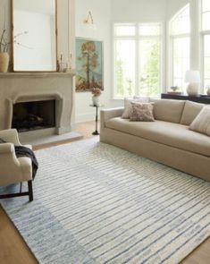 a living room filled with furniture and a fire place in the middle of a room