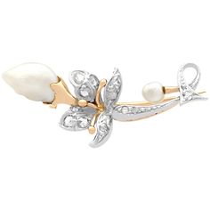 A fine and impressive antique baroque pearl and silver set diamond brooch in 9 karat yellow gold; part of our antique brooch and estate jewelry collections. This impressive antique diamond and pearl brooch has been crafted in 9 karat yellow gold with silver settings. The naturalistic design features a yellow gold set baroque pearl 'bud' and terminal. The scrolling stem and leaves are embellished with thirteen silver set, Dutch cut diamonds. This fine example of early Victorian craftsmanship is f Gold Brooch, Antique Brooches, Diamond Brooch, Yellow Gold Setting, Gold Brooches, Pearl Brooch, Victorian Jewelry, Antique Diamond, Gold Set