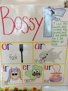 a sign that says bossy on it in front of a whiteboard with pictures of animals and words