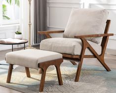 a chair and ottoman in a living room with a rug on the floor next to it