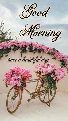 a bicycle with pink flowers on the front wheel and words good morning have a beautiful day