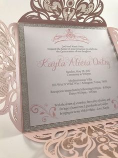 an ornate pink and silver wedding card